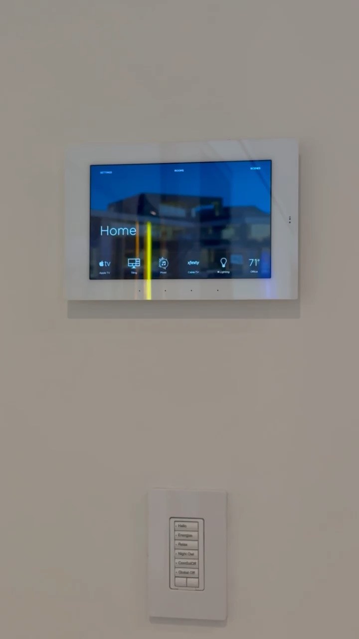 Wall-mounted touch panel controlling lighting, shades and audio