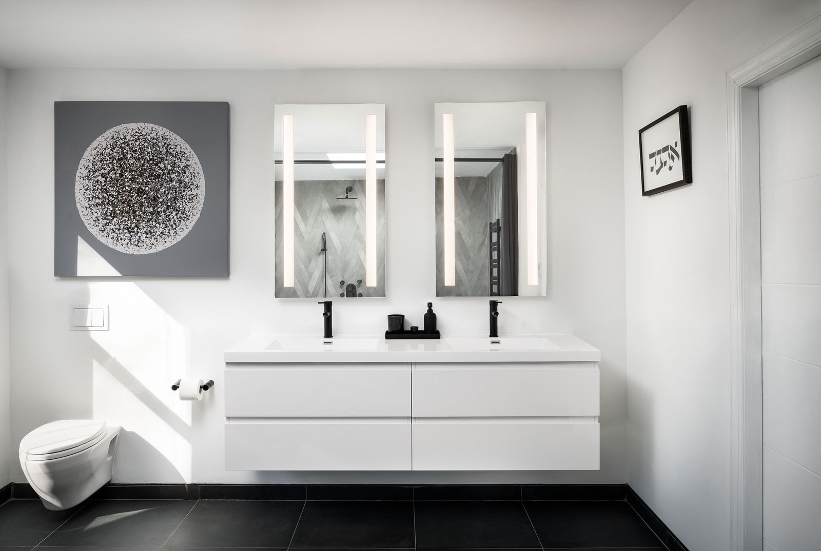 A S&eacute;ura Lumin lighted mirror with vertical LED lighting at a bathroom vanity