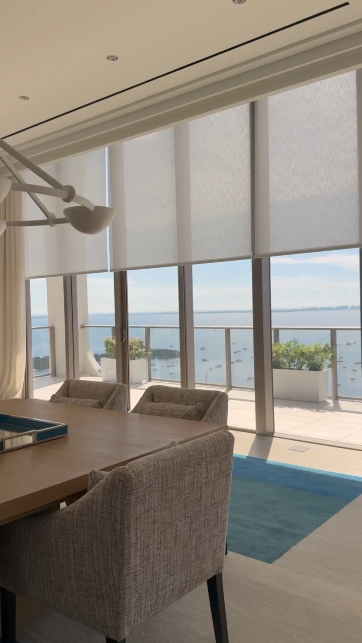 Floor-to-ceiling hurricane glass with a bay view in a Miami waterfront home